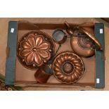 A collection of copper ware comprising two Victorian jelly moulds,