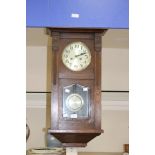 An early 20th century oak cased eight day wall clock,