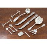 A group of silver flatware including tea strainer, Sheffield 1964, a pair of silver knife rests,