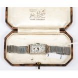 A white gold 9ct watch set with diamond chips,