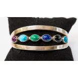 A silver bracelet set with cabochon, malachite, turquoise, Jasper, etc,