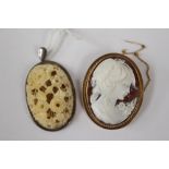 An early 20th century, possibly Dieppe carved ivory pendant with silver/white metal casing and loop,