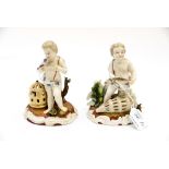 A pair of porcelain German putti figures,