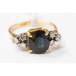 A sapphire and diamond ring, claw set with a central mixed cut sapphire approx 2.