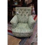 A late Victorian deep buttoned upholstered armchair,