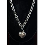 A Tiffany silver heart pendant necklace, approx 2.04 ozt, having yellow metal key.