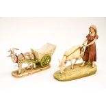 A Royal Dux porcelain figure of a young girl and goat standing on a grassy verge,