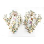 A pair of florally encrusted ceramic wall lights (2)