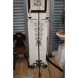 A contemporary wrought iron three light candle stand