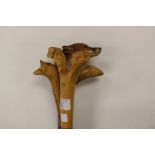 Three walking sticks: two thumbsticks with Dog's head design and one with Fox's head design;