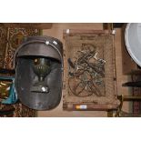 A basket of horse items including boot pulls and stirrups,