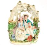 Early Staffordshire flat back figure of a couple sat beneath tree with a dog