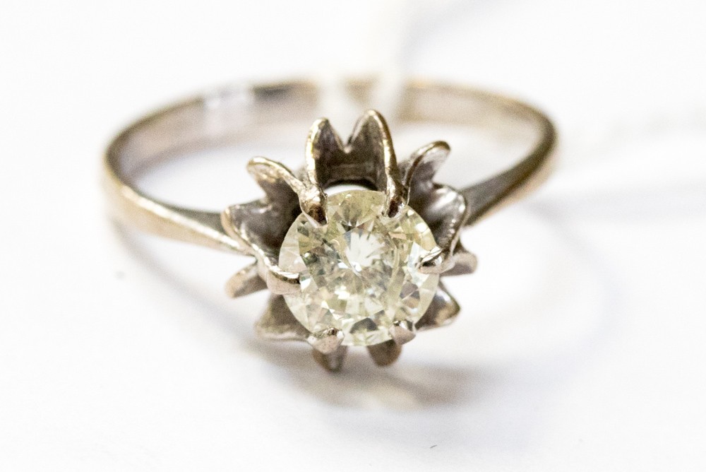 A diamond solitaire set in white metal, probably 18ct gold, with a fancy claw setting,