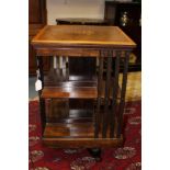 An Edwardian walnut and inlaid revolving bookcase