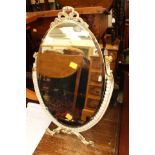 A white and gilt framed oval dressing table mirror