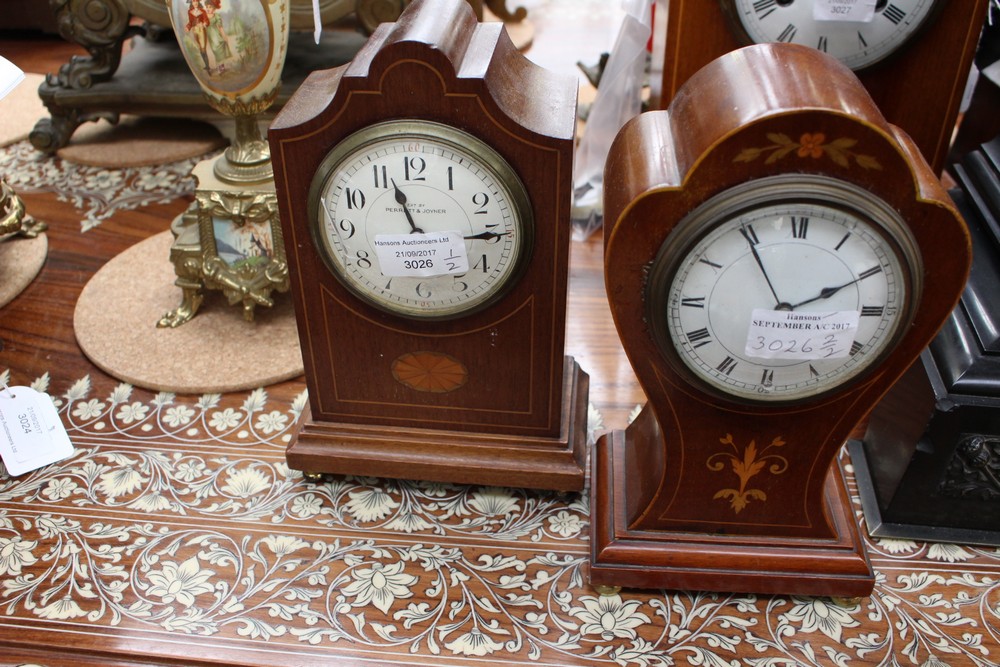 A fruitwood mantle clock, inlaid with satinwood on brass bun feet,