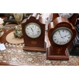 A fruitwood mantle clock, inlaid with satinwood on brass bun feet,