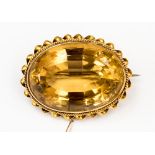 A citrine and yellow metal (possibly 18ct gold) brooch, the stone measuring approx 30mm long,