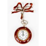 A white metal and red enamel ladies pocket watch with seed pearl bird to reverse,