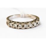 A diamond, seven stone 18ct white gold half eternity ring, with claw settings,