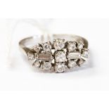 A diamond oval cluster 18ct white gold ring, filigree round brilliant and baguette cut diamond,