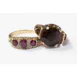 A 9ct gold, ruby and diamond boat ring, featuring three oval rubies and grain set diamonds,