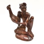 A hardwood carving of Indian man with fighting cockerel