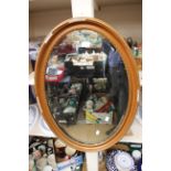 An oval bevelled mirror,