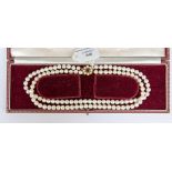 A double row choker necklace of cultured pearls,