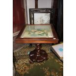 An early Victorian rosewood centre table, the top with a woolwork panel,
