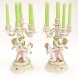 A pair of Capo de Monte figural candelabra of two cherubs (2)