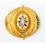 A Victorian etruscan yellow metal brooch, bead decoration seed pearl set centre,