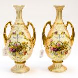 A pair of Continental blush ivory twin handled baluster vases, circa 1900,