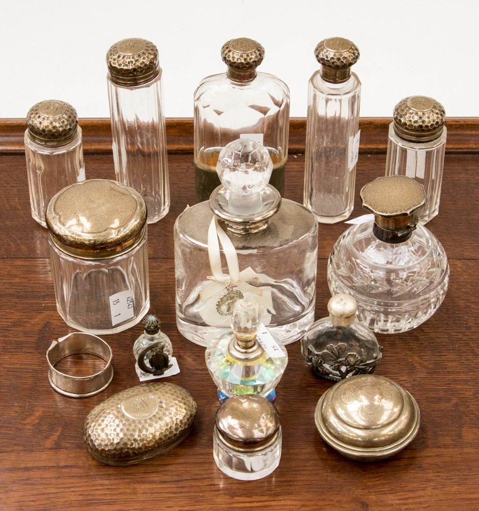 A collection of silver and scent bottles, dressing table bottles and a hip flask,