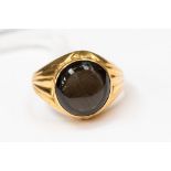 A high carat gold (tests as 20ct) signet ring set with a round tigers eye, size O1/2,