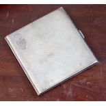 A silver cigarette case, engine turned body with initials G.P.