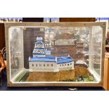 A cased large Japanese castle with various soldier figures surrounding it (1)