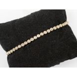 A diamond and 9ct gold tennis bracelet with illusion set diamonds, gross weight approx 5.