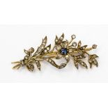 An Edwardian floral spray brooch set with a Ceylon sapphire and diamonds,