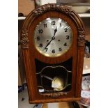 A Jacobean style oak cased German wall clock, circa 1930s, Arabic numerals,