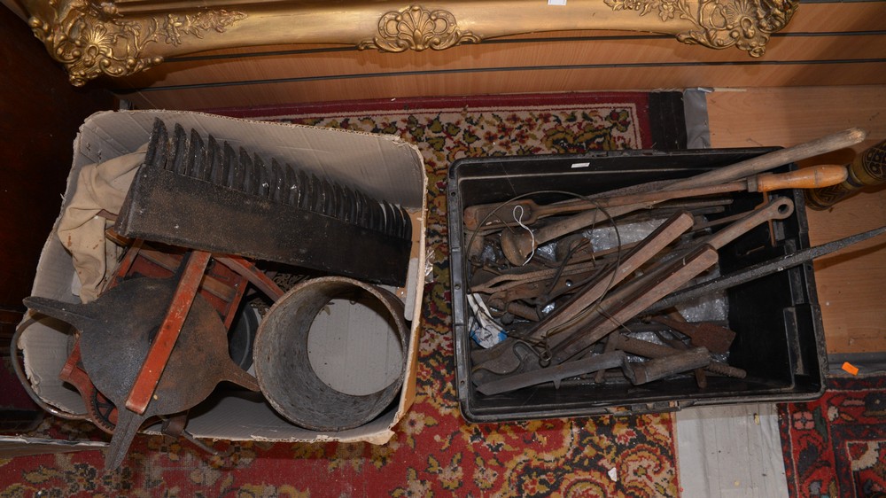 A box of tools with a seed spreader,