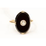An onyx and diamond set 18ct gold signet ring,