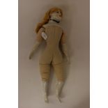 A French Doll with painted face, stuffed textile body and porcelain head/shoulders and half limbs,