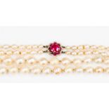 A double strand graduated cultured pearl necklace with synthetic ruby and small rose cut diamond