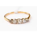 An 18ct five stone diamond ring, millegrain set five graduated old cut diamonds,