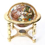 A decorative globe inlaid with semi precious stones,