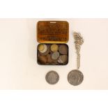 A collection of mixed coins including a silver dollar