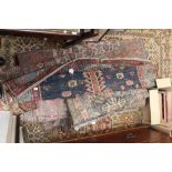 A collection of seven early 20th century hand made woollen rugs,