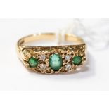 An Emerald and diamond boat ring in 9ct gold, size M, with a total gross weight 2.