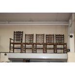 A set of eight solid beech rush seated ladder back chairs,
